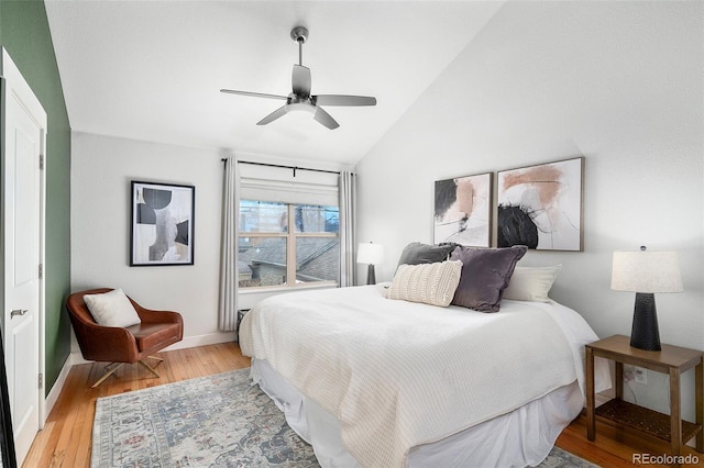 bedroom with lofted ceiling, a ceiling fan, baseboards, and light wood finished floors