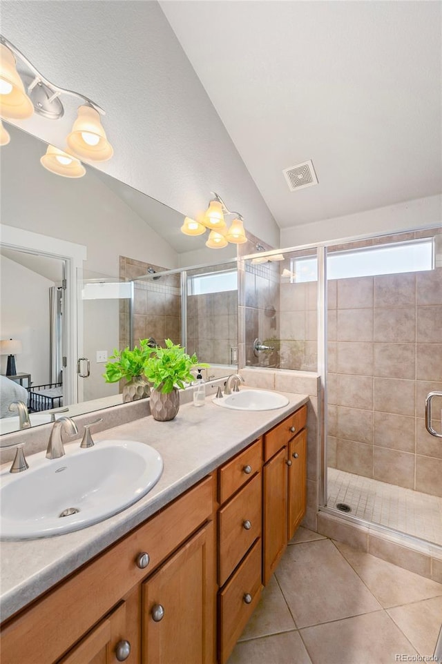 full bath featuring tile patterned flooring, vaulted ceiling, and a sink