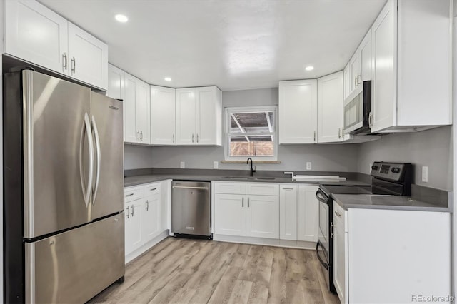 kitchen with white cabinetry, appliances with stainless steel finishes, and sink