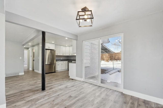 unfurnished living room with light hardwood / wood-style floors