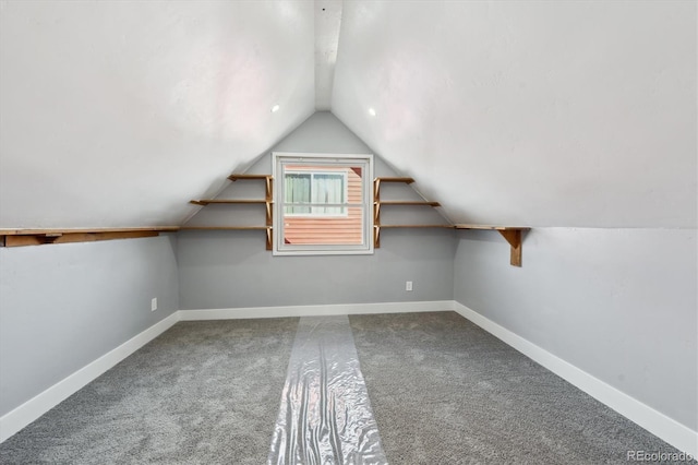 bonus room with lofted ceiling and carpet floors