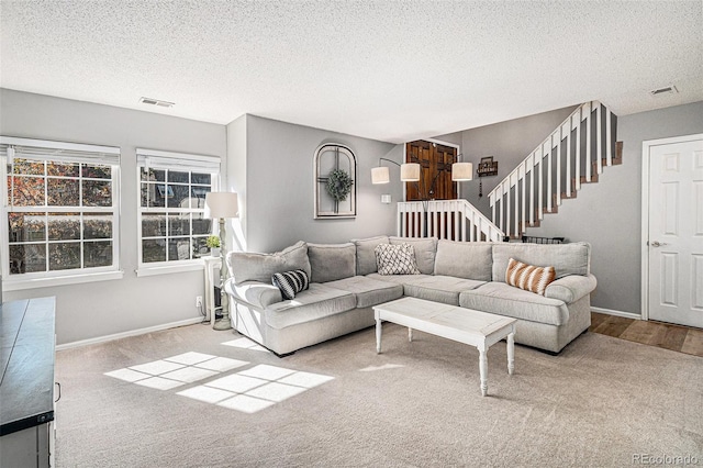 living room with light carpet and a textured ceiling