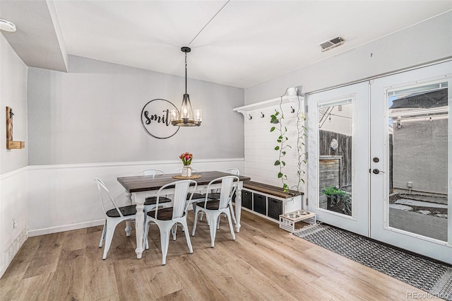 dining area featuring french doors and light wood-type flooring