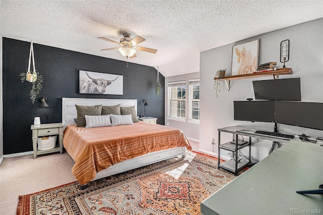 bedroom featuring a textured ceiling, ceiling fan, carpet floors, and lofted ceiling