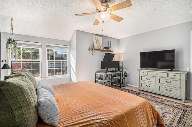 bedroom with a textured ceiling and ceiling fan