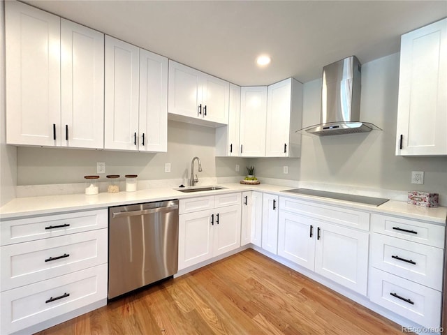 9451 E Evans Pl, Denver, CO 80231 - kitchen with wall chimney range hood, stainless steel dishwasher, light wood finished floors, white cabinetry, and black electric cooktop