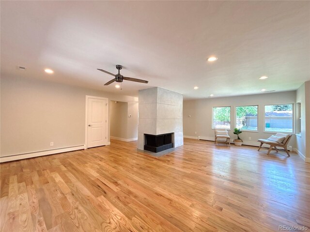 9451 E Evans Pl, Denver, CO 80231 - living area featuring a baseboard heating unit, light wood-style floors, recessed lighting, a multi sided fireplace, and ceiling fan