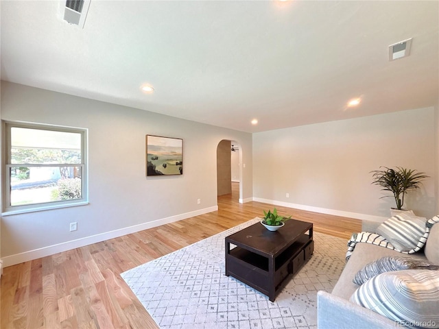 9451 E Evans Pl, Denver, CO 80231 - living area featuring arched walkways, light wood-style floors, and recessed lighting