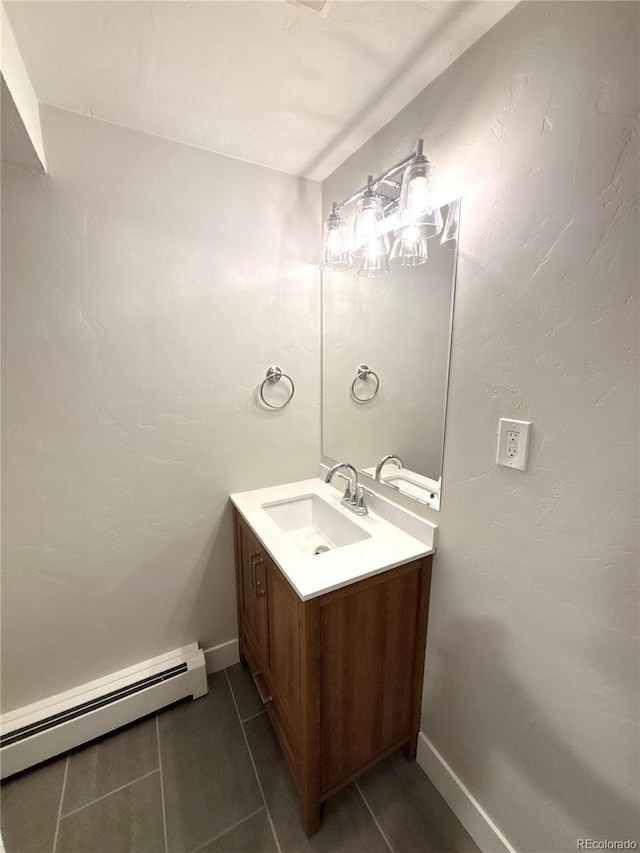 9451 E Evans Pl, Denver, CO 80231 - bathroom with a baseboard heating unit and vanity
