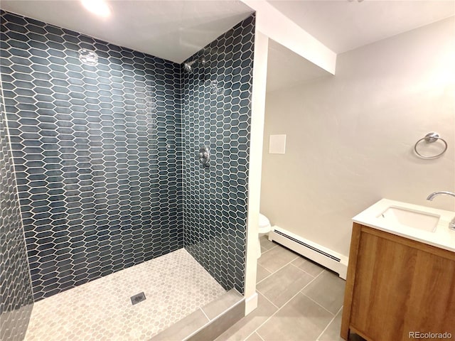 9451 E Evans Pl, Denver, CO 80231 - bathroom featuring a baseboard radiator, tiled shower, vanity, and tile patterned flooring