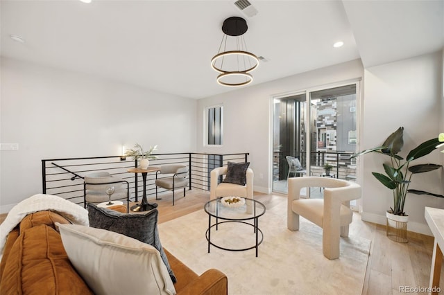 living room featuring light wood-style floors, baseboards, and recessed lighting