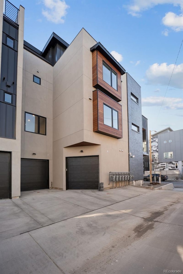 view of property with a garage and driveway