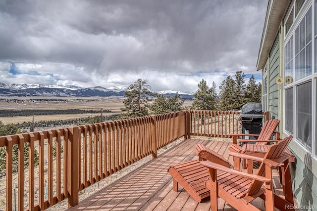 wooden deck featuring a grill and a mountain view