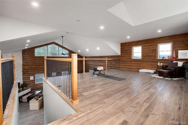 57 Overlook Ct, Idaho Springs, CO 80452 - workout area with rustic walls, wood finished floors, vaulted ceiling, a stone fireplace, and recessed lighting