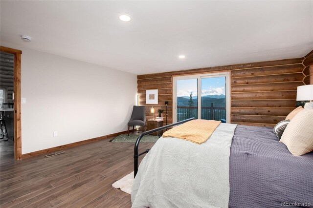 57 Overlook Ct, Idaho Springs, CO 80452 - bedroom with wood finished floors, log walls, recessed lighting, and access to exterior