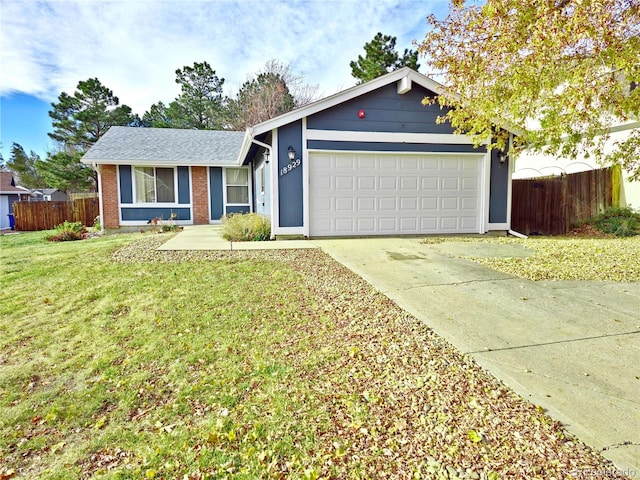 ranch-style house featuring a front yard and a garage