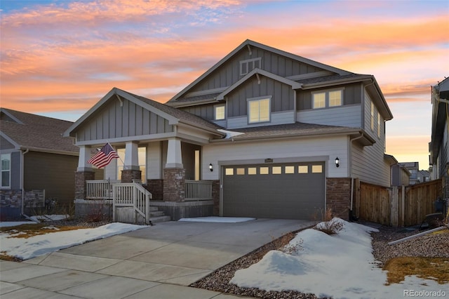 craftsman inspired home featuring a garage and covered porch