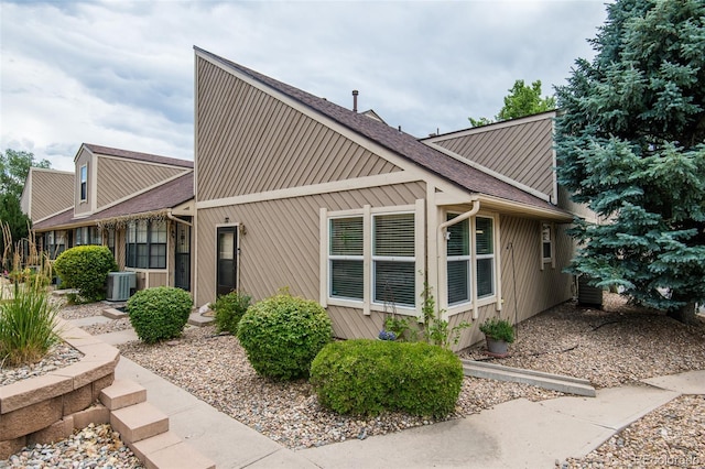 3300 W Florida Ave Unit 37, Denver, CO 80219 - view of side of home with a central AC unit and a shingled roof