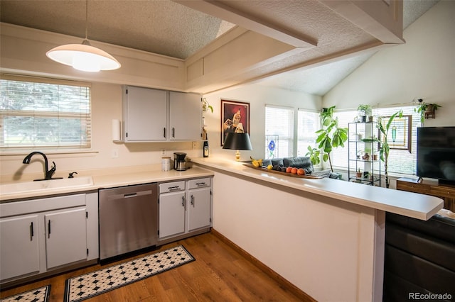 3300 W Florida Ave Unit 37, Denver, CO 80219 - kitchen featuring stainless steel dishwasher, a textured ceiling, light wood finished floors, light countertops, and a peninsula