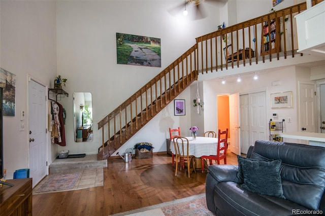 3300 W Florida Ave Unit 37, Denver, CO 80219 - living room featuring a high ceiling, stairway, and wood finished floors