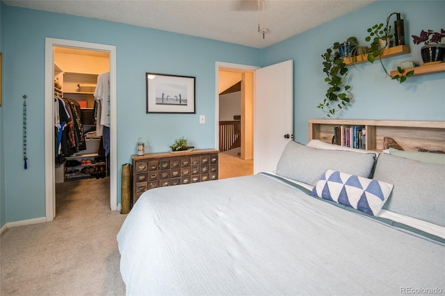 3300 W Florida Ave Unit 37, Denver, CO 80219 - bedroom featuring a walk in closet, light carpet, and ceiling fan