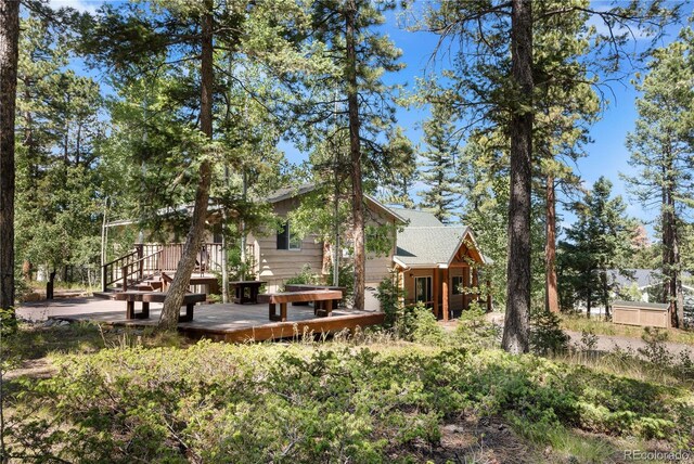 back of house with a wooden deck