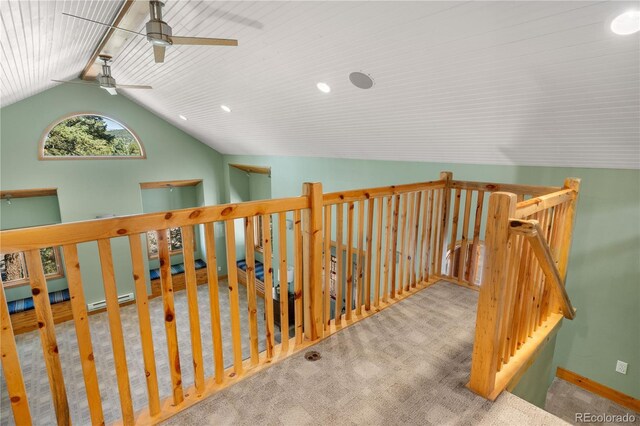 hallway with baseboards, vaulted ceiling, carpet flooring, and an upstairs landing