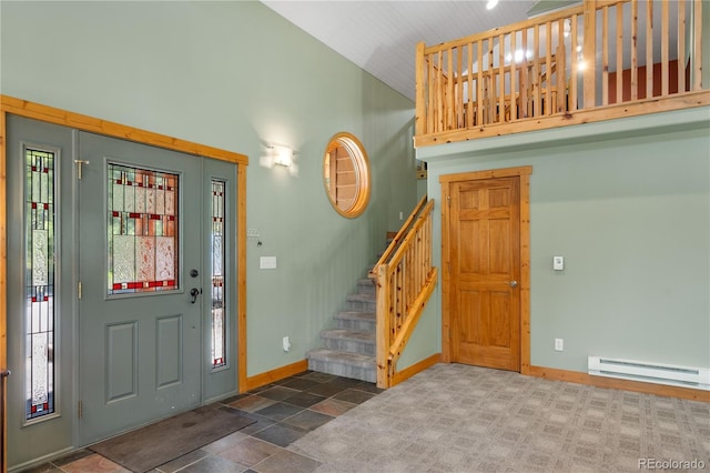 entrance foyer featuring high vaulted ceiling, a baseboard radiator, baseboards, and stairs