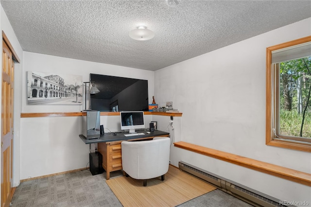 office area featuring a baseboard radiator, baseboards, a textured ceiling, and light colored carpet