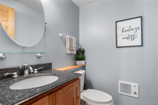 bathroom featuring toilet and vanity