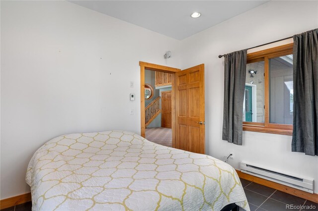 bedroom featuring recessed lighting, baseboard heating, and tile patterned floors