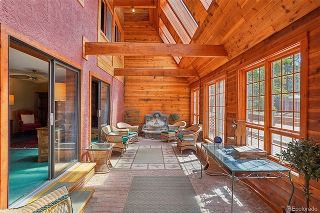 unfurnished sunroom with vaulted ceiling with skylight