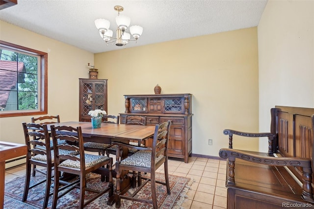 dining space with light tile patterned floors, baseboard heating, an inviting chandelier, and a textured ceiling