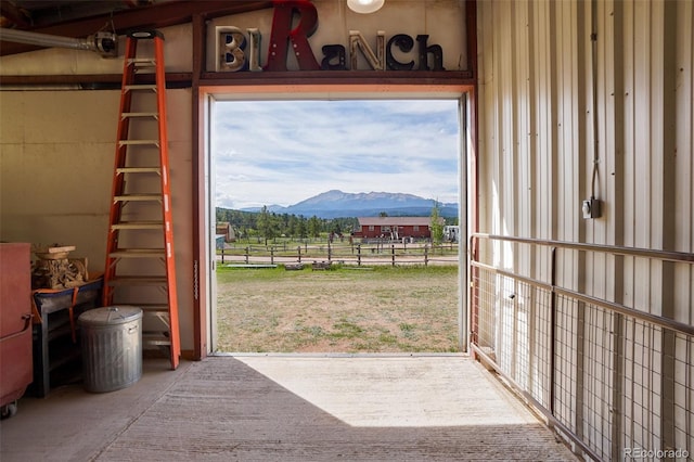 entryway featuring a mountain view and concrete flooring