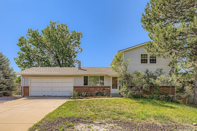 7542 Otis St, Arvada, CO 80003 - split level home with brick siding, a garage, driveway, and a front yard