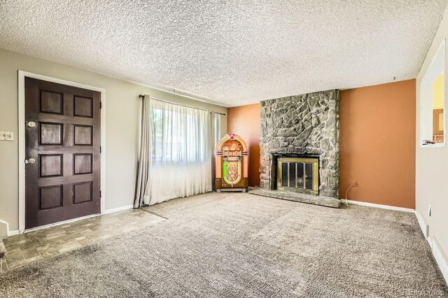 7542 Otis St, Arvada, CO 80003 - unfurnished living room with a fireplace and a textured ceiling