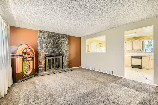 7542 Otis St, Arvada, CO 80003 - unfurnished living room featuring a textured ceiling, light colored carpet, and a stone fireplace