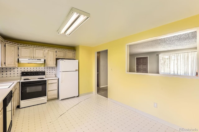 7542 Otis St, Arvada, CO 80003 - kitchen with white appliances, under cabinet range hood, light countertops, light floors, and decorative backsplash