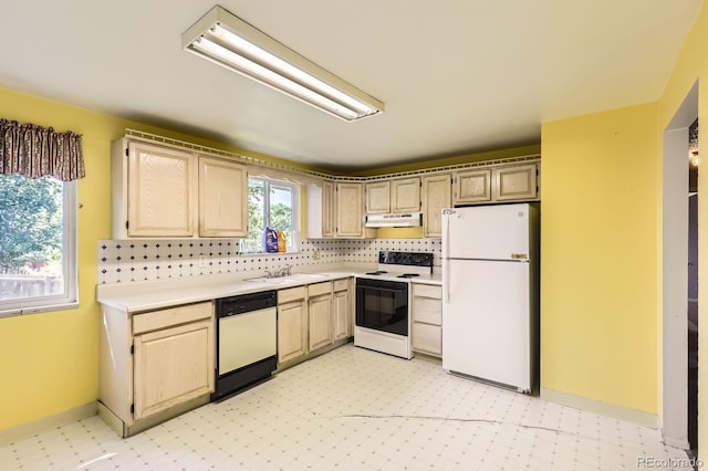 7542 Otis St, Arvada, CO 80003 - kitchen with white appliances, under cabinet range hood, light countertops, light flooring, and backsplash