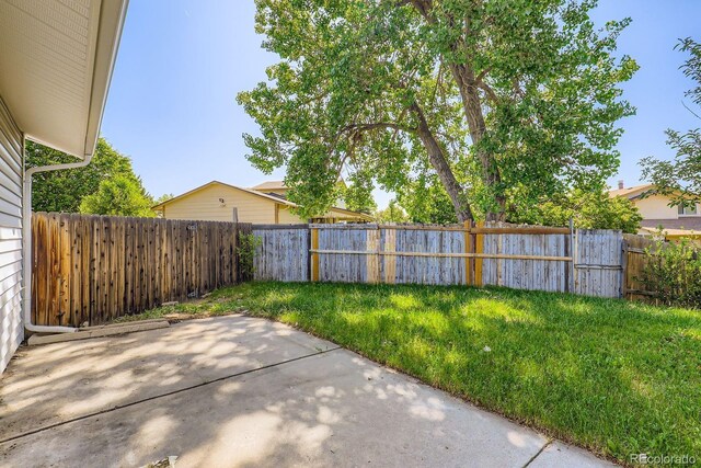 7542 Otis St, Arvada, CO 80003 - fenced backyard featuring a patio area