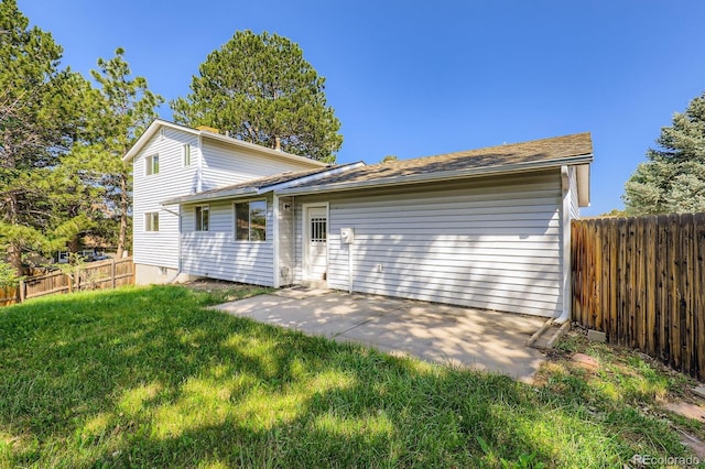 7542 Otis St, Arvada, CO 80003 - rear view of house with a fenced backyard, a patio area, and a shingled roof