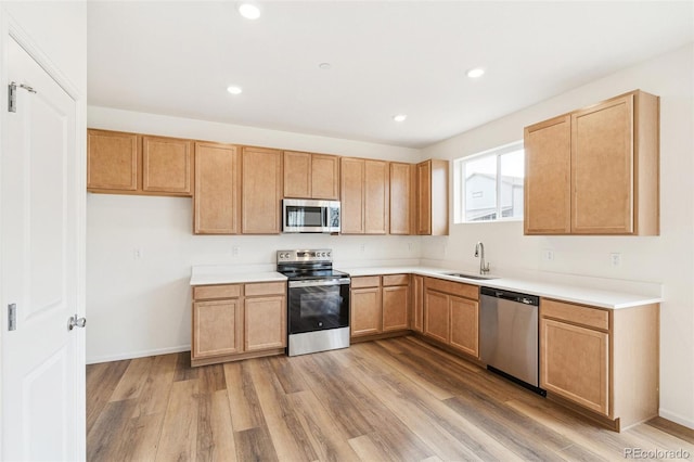 13402 E 110th Way, Commerce City, CO 80022 - kitchen with appliances with stainless steel finishes, light wood-style floors, light countertops, recessed lighting, and light brown cabinets