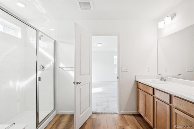 13402 E 110th Way, Commerce City, CO 80022 - full bathroom featuring wood finished floors, vanity, and a shower stall