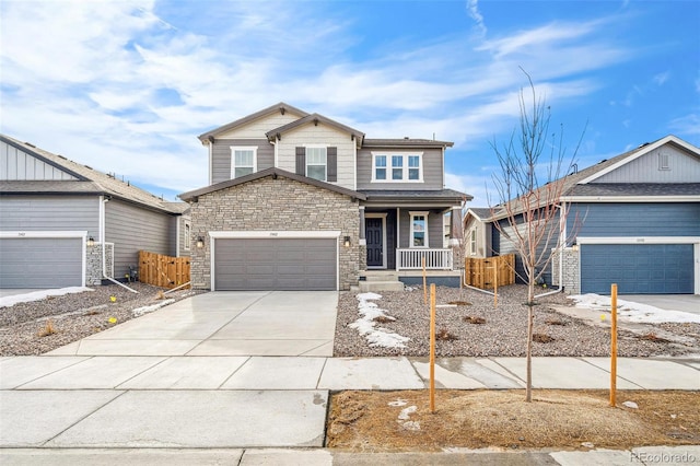 13402 E 110th Way, Commerce City, CO 80022 - view of front of property featuring a porch, driveway, a garage, and stone siding