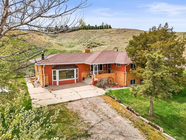 12101 Riverdale Rd, Brighton, CO 80602 - single story home with dirt driveway, a chimney, and a porch