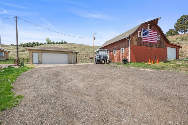 12101 Riverdale Rd, Brighton, CO 80602 - view of home's exterior featuring a detached garage, a barn, and an outbuilding
