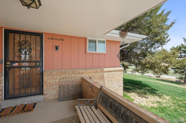 12101 Riverdale Rd, Brighton, CO 80602 - doorway to property featuring brick siding and board and batten siding