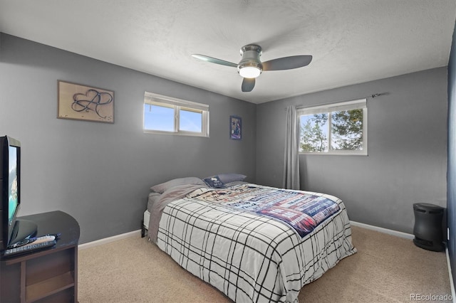 12101 Riverdale Rd, Brighton, CO 80602 - bedroom featuring carpet floors, multiple windows, ceiling fan, and a textured ceiling