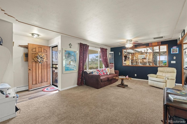 12101 Riverdale Rd, Brighton, CO 80602 - carpeted living area featuring ceiling fan, a baseboard heating unit, and a textured ceiling