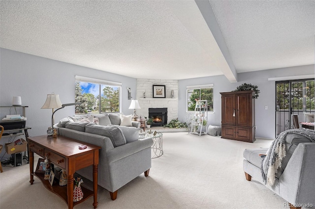60 S Moline St, Aurora, CO 80012 - living room with light colored carpet, a textured ceiling, plenty of natural light, a fireplace, and beamed ceiling